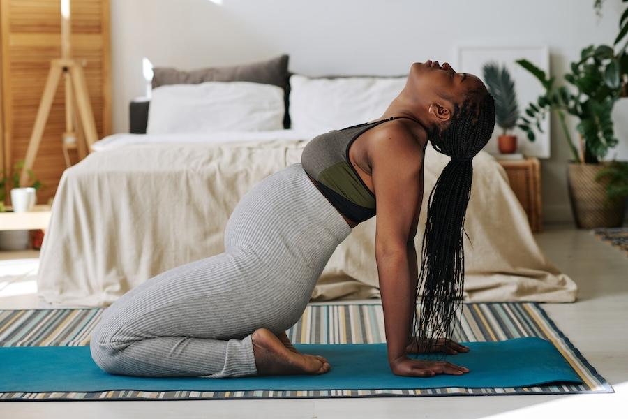Pregnant-woman-meditating-on-exercise-mat-2260749